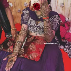 For this bride, we designed full-arm mehandi that tells her story through different panels, combining traditional motifs with personal moments. This is a perfect example of narrative bridal henna.