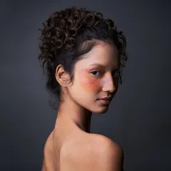 This is makeup as art. I used a wash of warm, diffused color across the eyes and cheeks, adding faux freckles for a unique, sun-kissed look that feels both natural and conceptual.