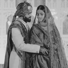 The same moment, captured in classic black and white. This style strips away the color to focus purely on the emotion and the regal connection between the couple.