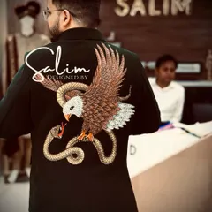 The back of this blazer is a canvas for detailed threadwork, showing an eagle and snake. This is an example of my custom embroidery service, where we can create any powerful animal motif you envision.