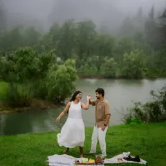 A moment of pure, carefree joy. This couple's playful dance during their lakeside picnic captures the fun and spontaneity I love to see in a pre-wedding session.