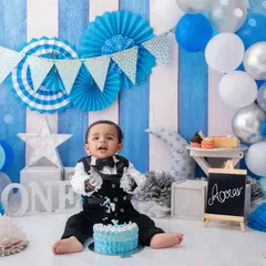 The moment of truth. This little boy dives right into his first birthday cake, a perfect capture of his curious and playful nature.