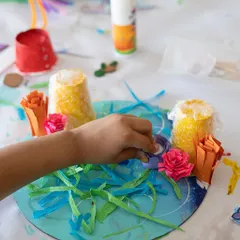 Assembling the sculpture, this child adds paper seaweed and other elements to the base. This stage is all about composition and bringing the different handmade components together.