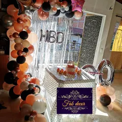 Balloon decorations are great for any age. Here is a 40th birthday party setup I did in a client's home, featuring a stylish balloon arch over the cake table in peach, black, and white, with large "40" foil balloons.