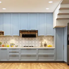 This kitchen showcases a classic shaker-style design in a calming powder blue. The patterned tile backsplash adds a touch of personality, while the wooden flooring brings warmth to the space.
