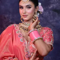 Learn the art of creating the perfect traditional bridal look. This image showcases the intricate details, from flawless makeup to classic hairstyling, that we teach in our professional makeup artistry courses.