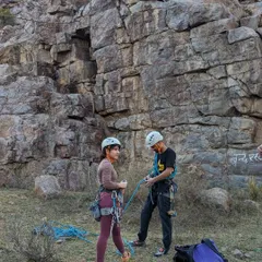 Getting geared up for a day of sport climbing at Gritfest in Dhauj. An instructor double-checks a climber's harness and knots before she gets on the wall.