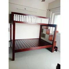 A classic solid wood bunk bed, perfect for a kids' room. This design features a sturdy frame, safety railings on the top bunk, and an integrated staircase with built-in drawers for storing toys and clothes.