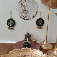 This set of Ganpati wall hangings is in a beautiful dark green, decorated with golden beads. They make a wonderful housewarming or Diwali gift.