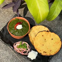 Nothing says winter comfort like our classic Sarson Ka Saag served with hot Makai Ki Roti. This traditional Punjabi dish is slow-cooked with fresh mustard greens and spices for an authentic, heartwarming flavor.