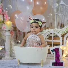 A dreamy splash session with a beautiful pastel and boho setup. She looks like a little fairy in her bubble bath.