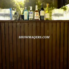 A well-stocked and stylish bar is essential for any gala. This rustic wooden bar, backlit with warm fairy lights, provided a central point for guests to mingle and enjoy refreshments.