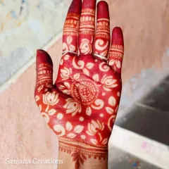 The magical moment when the henna stain is revealed. This is the beautiful, rich red colour of the cutwork design after the paste is removed.