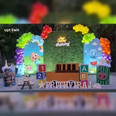 Another angle of the outdoor Cocomelon theme, highlighting the light-up name and character props that complete the look.