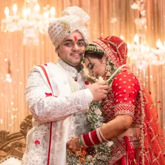 A tender moment right after the Varmala, where the groom helps the bride. These small, candid interactions are just as important as the main rituals.