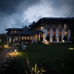 A masterful fusion of form and design, where architectural precision meets the serene beauty of nature. This farmhouse stands as a timeless expression of elegance amidst a sprawling lawn.