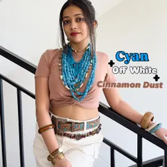 For a more earthy summer palette, try cyan, off-white, and cinnamon dust. I've layered chunky cyan necklaces over a neutral top and shorts to create a bohemian look that's perfect for a hot day.