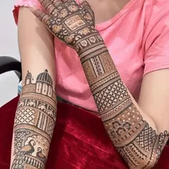 This unique design incorporates architectural elements like a temple dome, surrounded by peacocks and elephants. It blends structural art with traditional animal motifs.