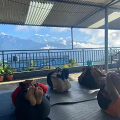 Students resting in a restorative pose during our yoga retreat. With the majestic mountains in the background, finding a state of deep peace and relaxation comes naturally.