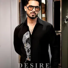 Art and attitude, stitched into one. This black shirt features a geometric, abstract face embroidered in silver and gold thread. It is a limited edition design for those who prefer their style to be a statement.