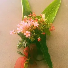 A beautiful bouquet created from flowers picked from a client's garden. The pink oleander and red Rangoon creeper show how a well-maintained garden can provide beauty both outdoors and indoors.