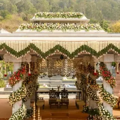 A magnificent temple-style mandap with a mountain view, showcasing how we integrate grand architecture with the natural beauty of your chosen venue.