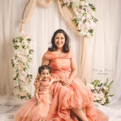 Creating memories stitched with love. This enchanting mother-daughter duo, Meghana and her little one, are twinning in elegant peach organza gowns I designed for their special Mother's Day photoshoot.