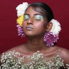 An editorial piece celebrating nature and color. I used a vibrant palette on the eyes and lips, complemented by fresh flowers, to create a look that feels both artistic and organic for this beauty photoshoot.