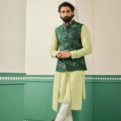 The complete ensemble, featuring a light green drape kurta with an embroidered emerald Nehru jacket, perfect for a groom's Mehendi.