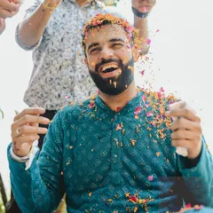 The groom's joyful reaction during his Haldi. These candid shots are full of energy and capture the true spirit of the celebration.