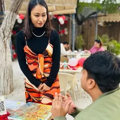 I love these moments of conversation and connection during my workshops. Here, I'm chatting with a participant about his artwork at our outdoor painting event. My goal is to create a comfortable space where everyone feels inspired to explore their creativity.