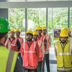 Our team lines up for a daily safety briefing. These meetings are crucial for ensuring everyone on site is aligned with our strict safety protocols before work begins.