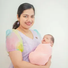 A beautiful portrait of a mother holding her sleeping newborn. My goal is to capture the pride and joy of new parenthood in a simple, elegant style.