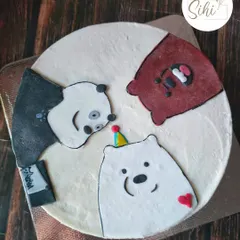 A cake for fans of We Bare Bears. This design features Grizz, Panda, and Ice Bear created with fondant, each with their own unique expression, celebrating together on one cake.