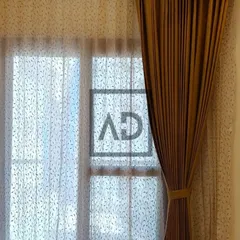 Here is a closer look at a layered curtain setup. The inner sheer curtain features a subtle leaf pattern, adding a decorative touch, while the outer solid curtain provides full privacy and light blocking when needed.