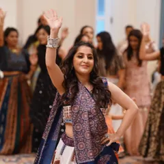 Leading the group in a Garba routine. I guide you through every step, ensuring the whole group moves together in beautiful synchrony.