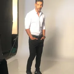 A classic, clean look for John Abraham during a studio shoot. A well-fitted white shirt and black trousers is a timeless combination that I often use for a sharp and sophisticated effect.