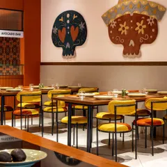 We paid homage to Mexican heritage with bold, artistic statements throughout Tres Amigos. These large, hand-tufted skull rugs, designed in collaboration with Studio Arisaa, reinterpret traditional motifs with vibrant colors, serving as striking focal points against the restaurant's clean walls.