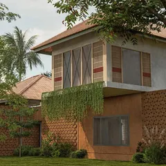 The design for this Palakkad residence features walls of hanging greenery and perforated brick, responding to the climate and celebrating natural materials.