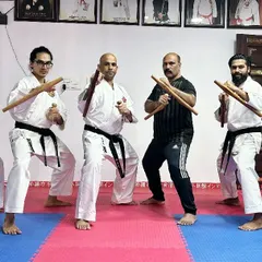A dynamic group pose with Tonfa, showcasing the stances and readiness associated with this traditional Okinawan weapon.