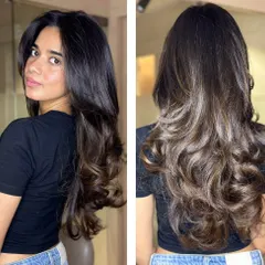 A before and after look at one of our layered haircuts. We added shape and texture to the client's long hair, finishing with a curly blowout to showcase the new style.