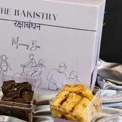 The perfect balance of sweet and savory for Raksha Bandhan. This shot highlights our gooey chocolate brownies and crunchy Cheese Knots, beautifully packaged in our nostalgic 'Memory Box'.