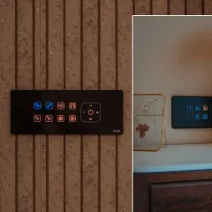 This smart panel features a combination of red and blue backlit icons, making it easy to distinguish between different functions at a glance. The panel is mounted on a textured wall, showing how it complements modern interiors.