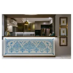 In this open-plan home, the kitchen counter becomes a canvas. I commissioned artisans from Jaipur to hand-paint this mural with traditional Rajasthani motifs, adding a surprising and soulful burst of Indian craft that connects the kitchen to the living space.
