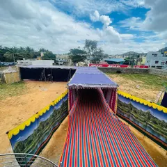A large-scale outdoor setup in Chitradurga. We can provide tents and covered walkways to create a comfortable dining space for your guests, no matter the location.