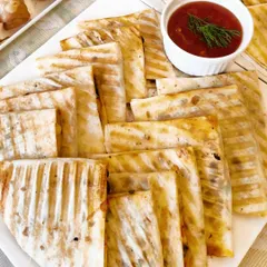 These grilled quesadillas are a perfect accompaniment to our burrito bowls or as a standalone snack. We offer a variety of fillings, including corn spinach, tricolour pepper, and a hearty three-bean mix.