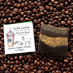 Our Café Latte Natural Soap resting on a bed of coffee beans. This bar combines the exfoliating power of coffee with the moisturizing properties of goat milk for a truly invigorating wash.