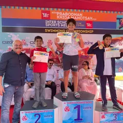 Celebrating a new record holder. Bryce stands proudly on the first-place podium at the 45th Prabodhan Krida Mahotsav after winning gold and setting a new meet record in the butterfly event. Our training focuses on developing the technique and power needed for such record-breaking swims.