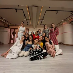 A happy group photo with my students after a class. The community and family we build in the studio is the most important part of my work.