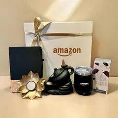 A sophisticated Diwali corporate gift curated for Amazon. This set includes an Amazon-branded tumbler and notebook, a backflow incense burner, and a decorative diya.